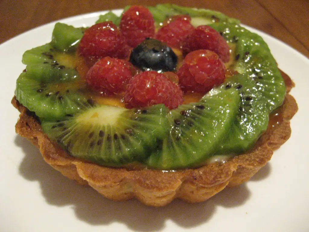 Fruit tart topped with kiwi and raspberries